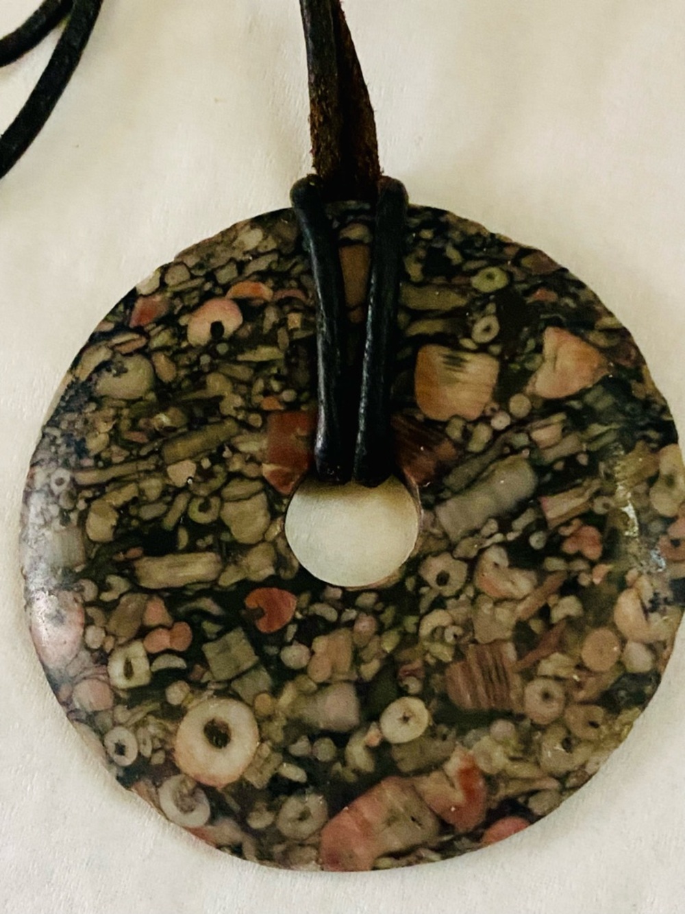 Fossilized crinoid donut pendant, Pi or Sea Lily Stone
- Black and Pink, unisex